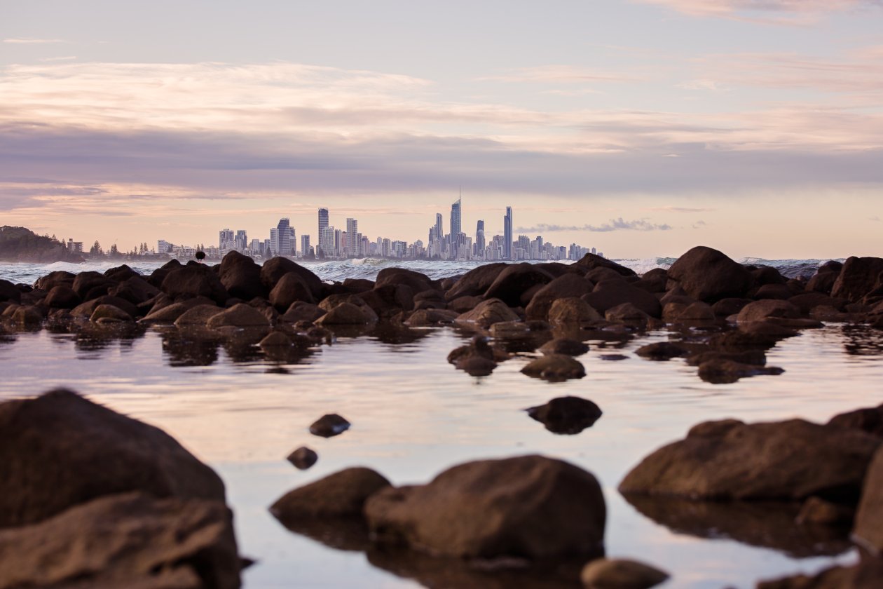 Seashore Rocks Near City View Of Buildings 5k