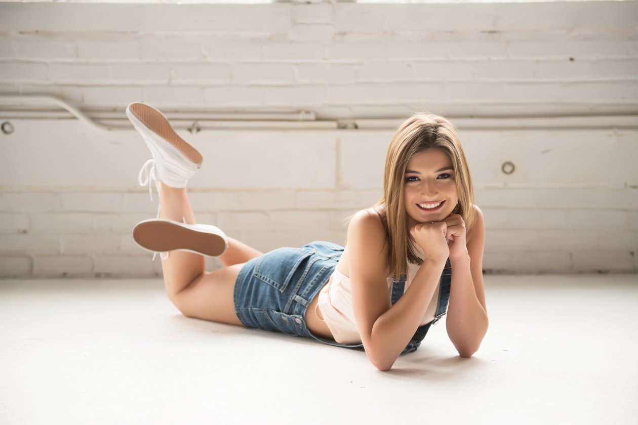 Cute Smiling Girl Laying On Front Floor