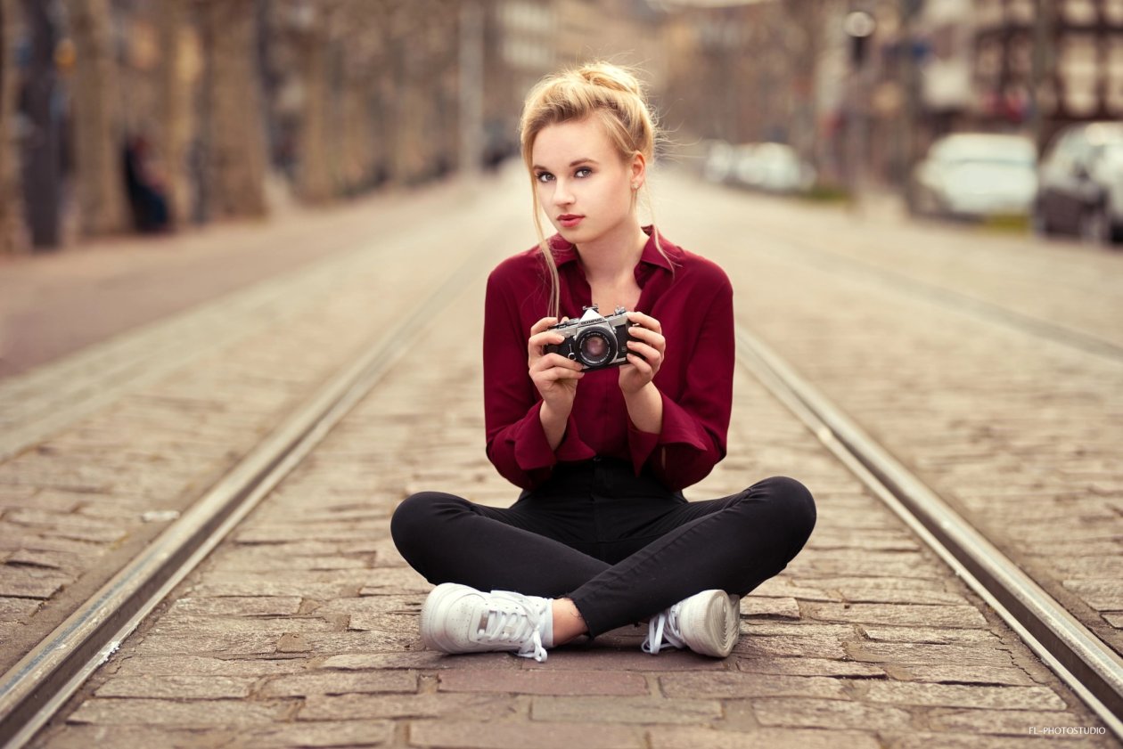 Girl With Camera Sitting On Tram Road