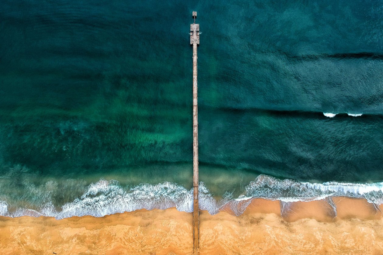 Aerial Shot Of Gray Dock On Body Of Water