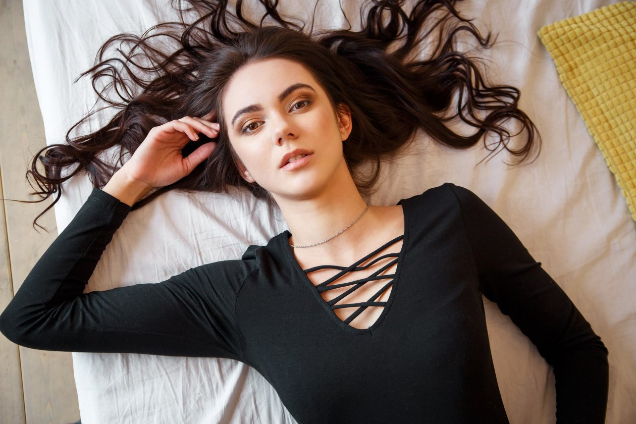 Girl Lying Down Looking At Viewer