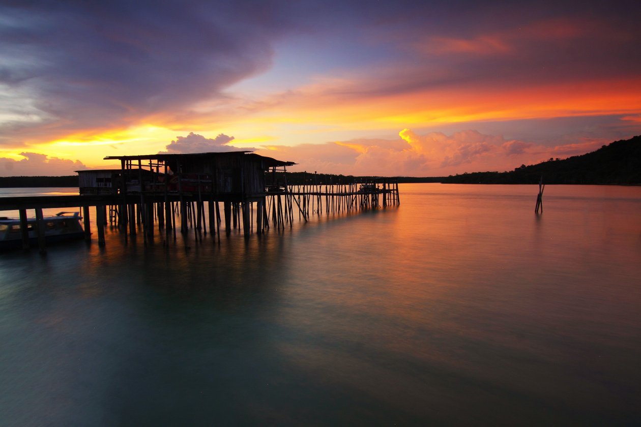 Silhouette Wooden Houses Above Sea Sunet