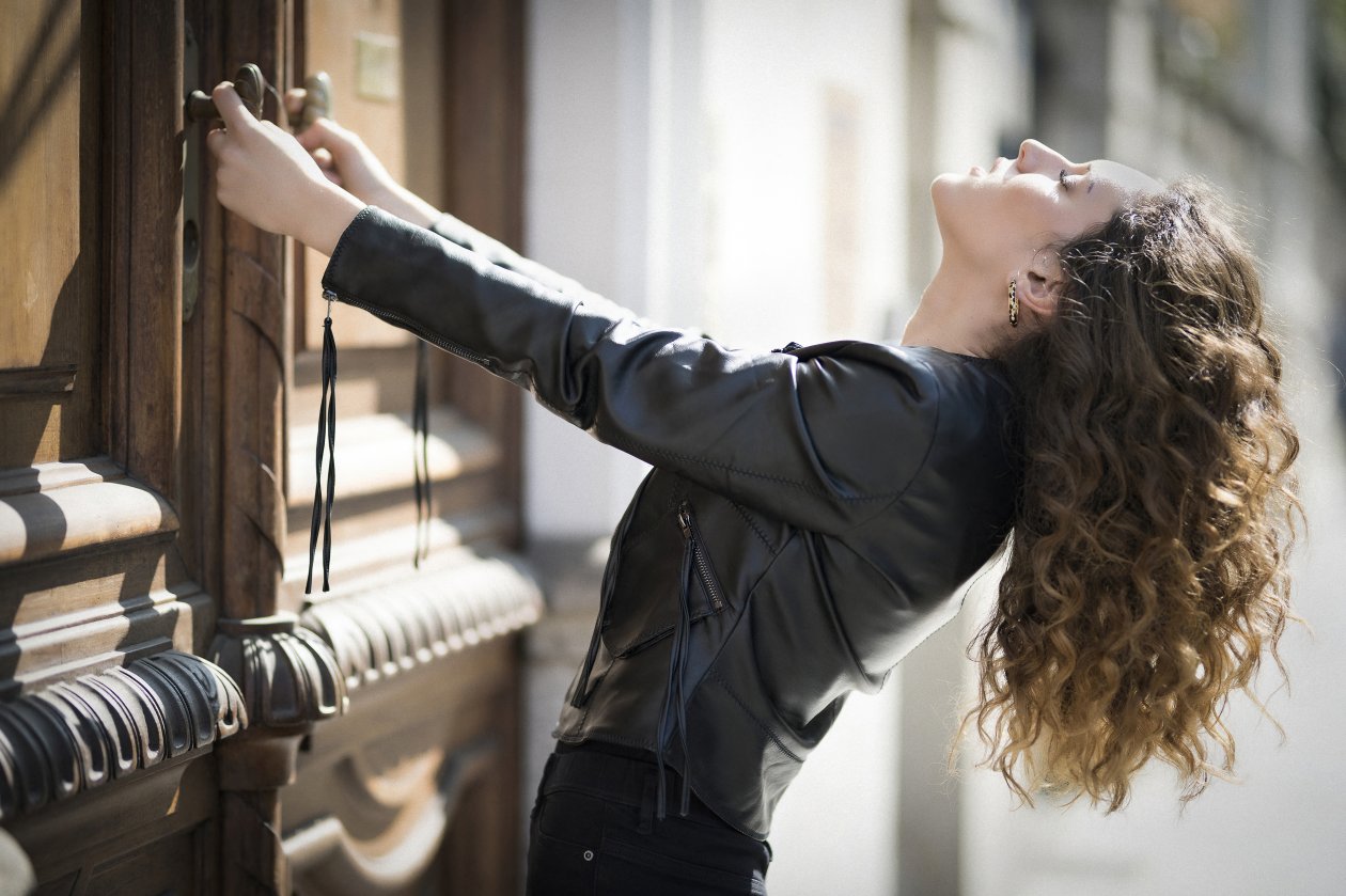 Girl Curly Hair Haning Down Black Jacket 5k