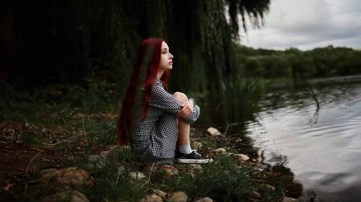 Girl Sitting At Lake Side View