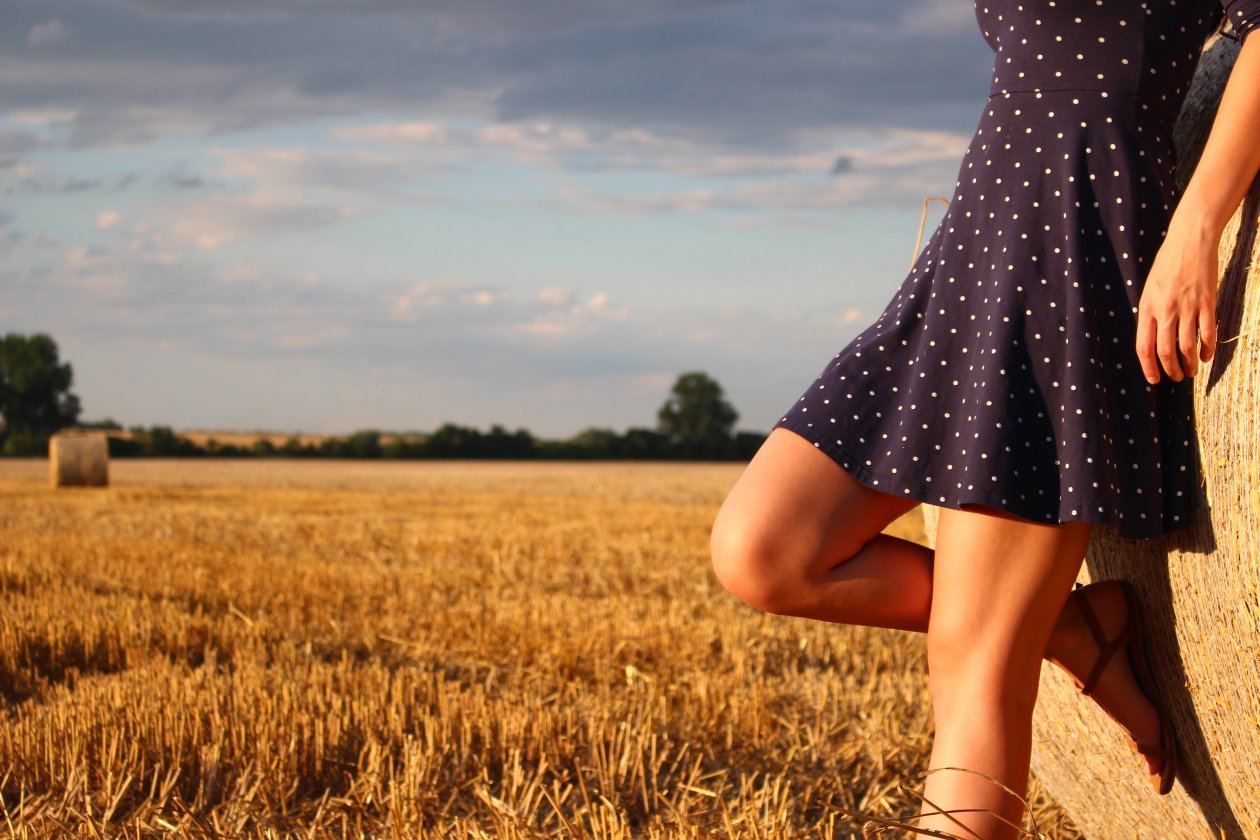 Girl Standing In A Field Wearing Polka Dot Dress