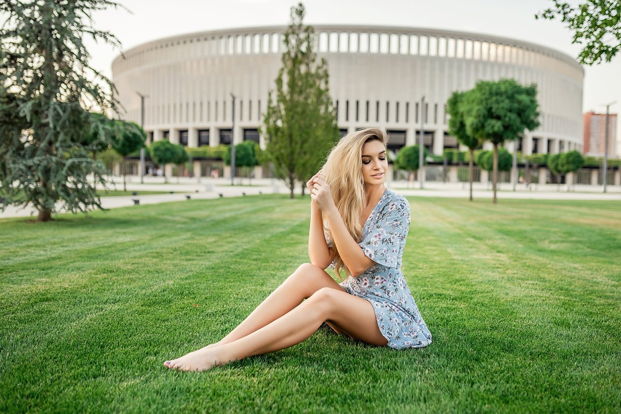 Blonde Girl Sitting In Park