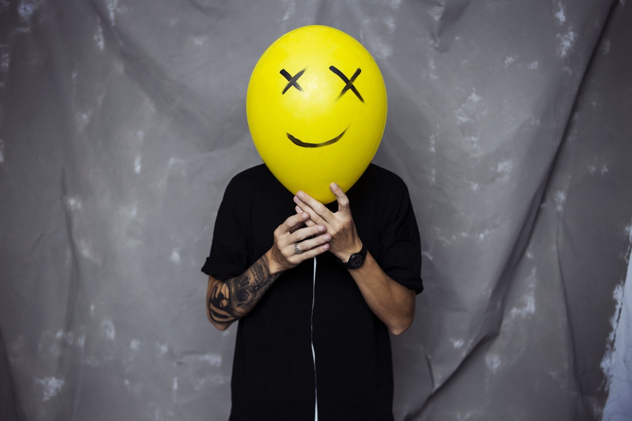 Boy With Smiley Balloon On Face
