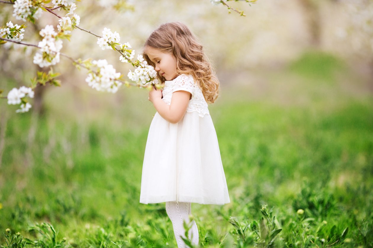 Little Cute Girl Smelling Flowers