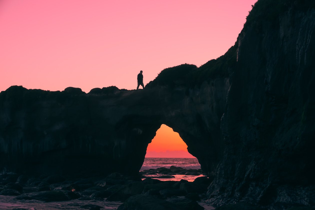 Man Walking Over Rock Silhouette