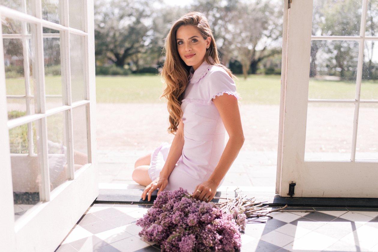 Women Sitting On Door With Flowers