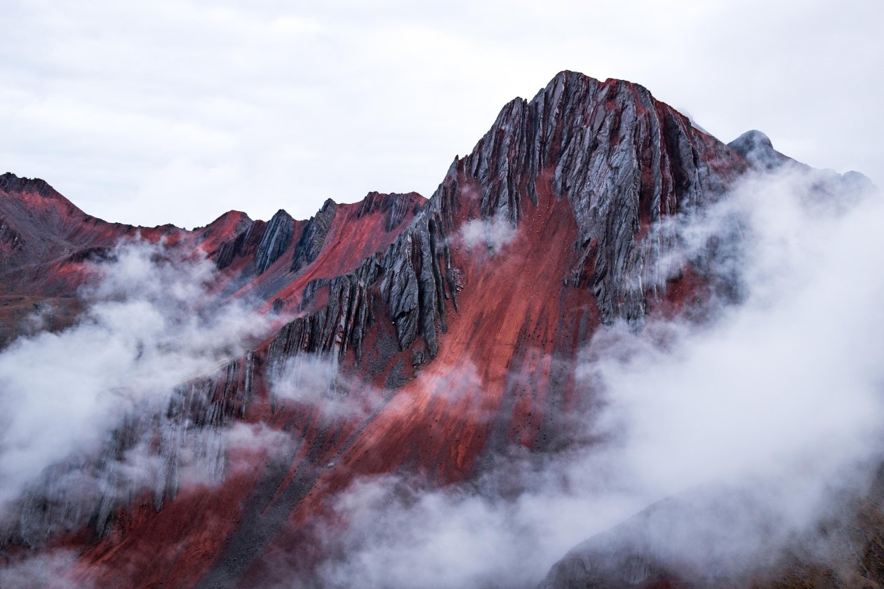 Red Mountain Peeking Out Behind The Clouds Cusco Peru