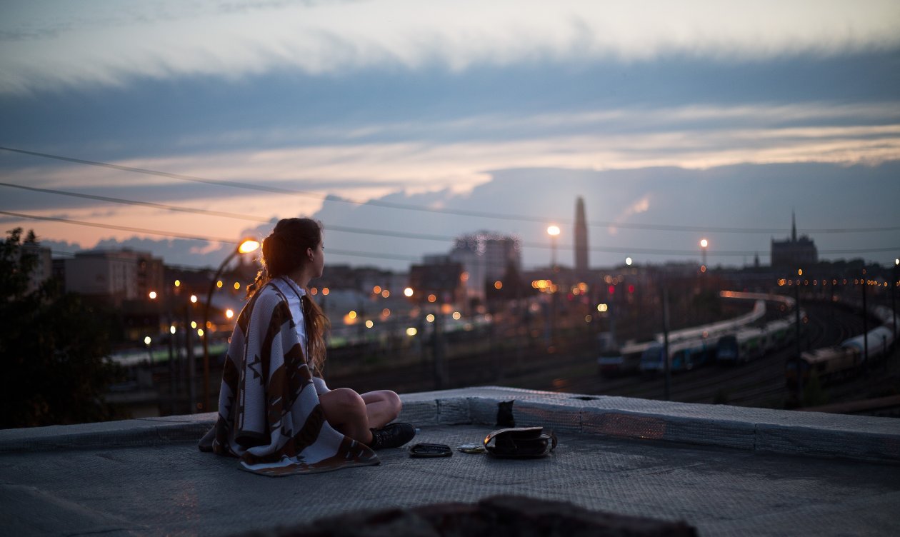 Girl Sitting On Rooftop Looking Towards Town 5k
