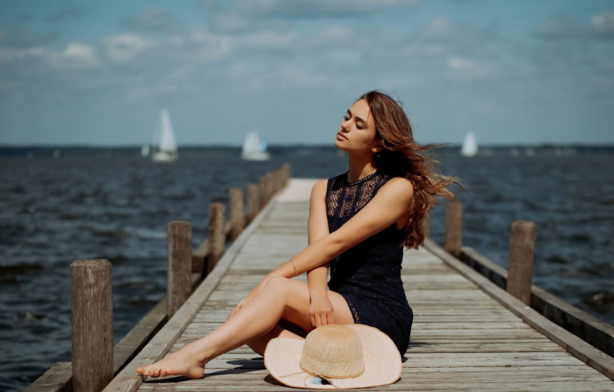 Girl Sitting On Pier Side Depth Of Field