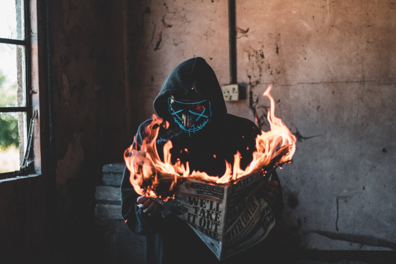 Hidden Mask Guy Burning Newspaper
