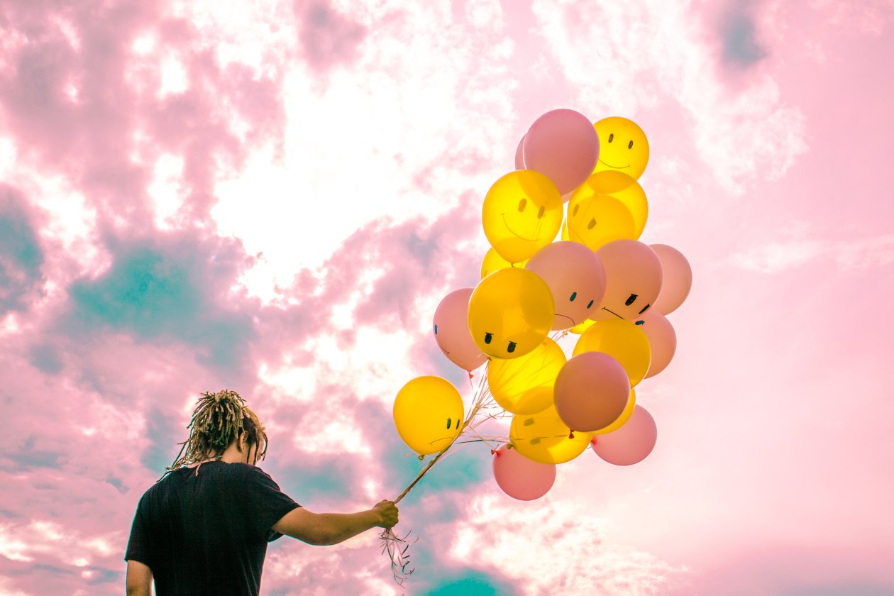 Boy With Happy And Sad Balloons