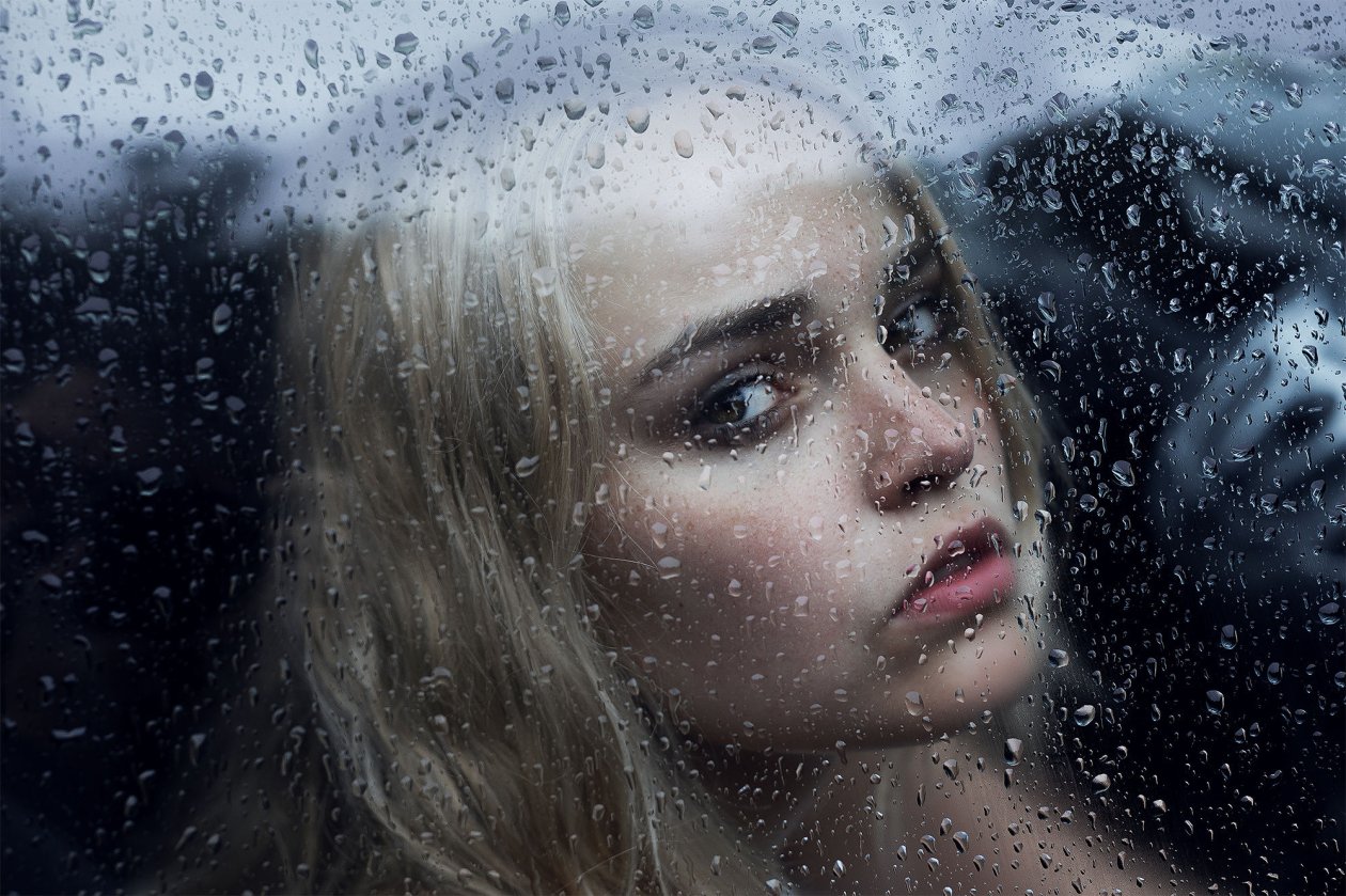 Girl Behind The Glass With Water Drops