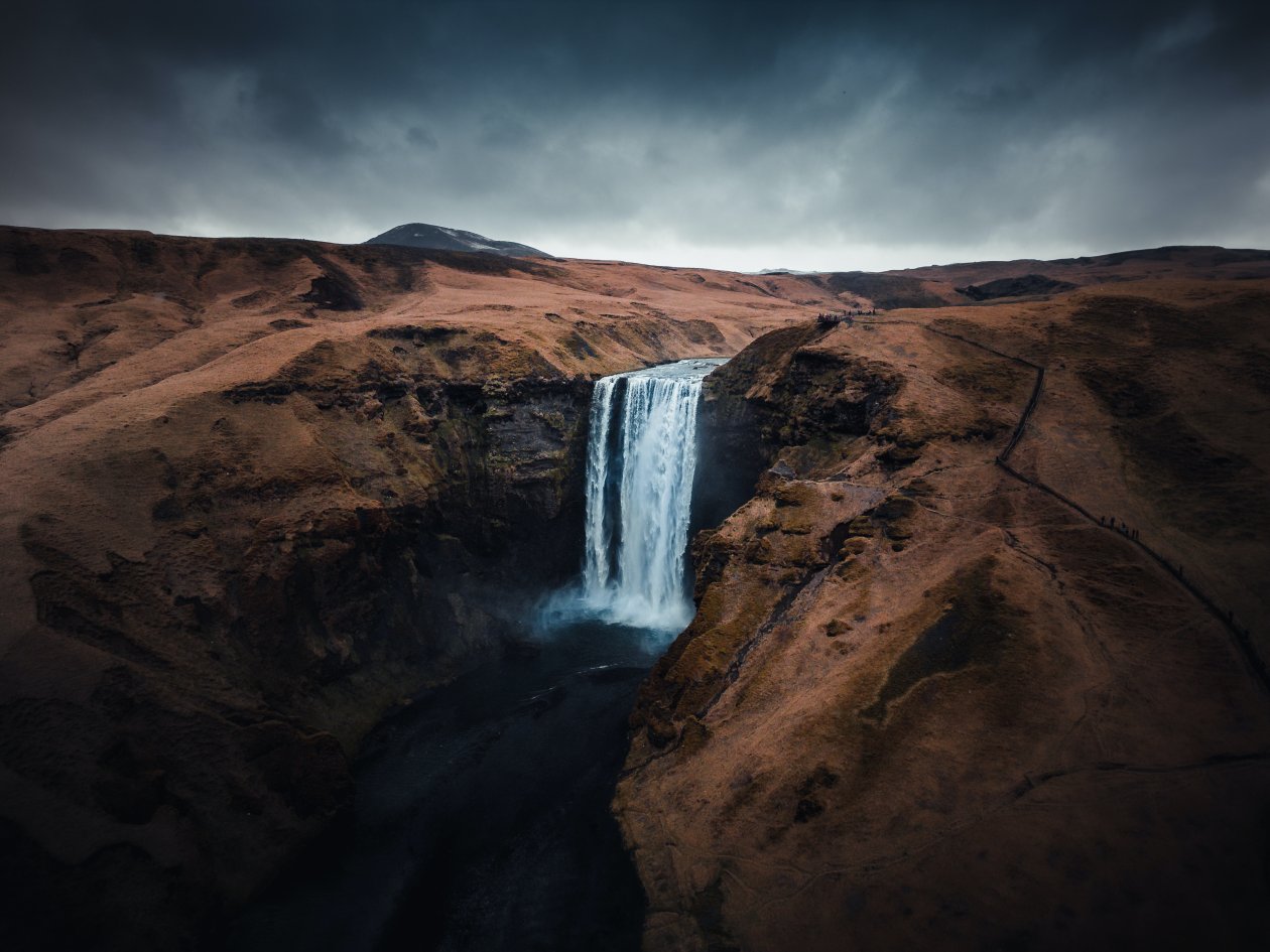 Waterfall In The Middle Of Mountains
