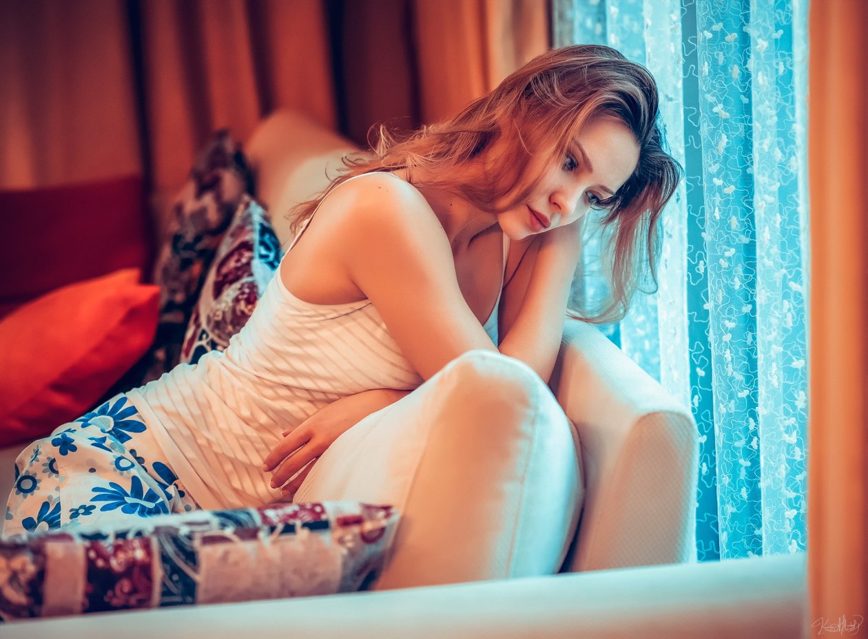 Girl Sitting On Couch Thinking