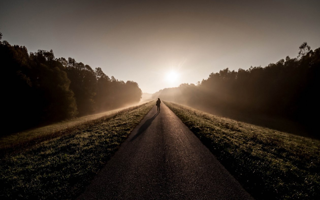 Person Standing Between Road