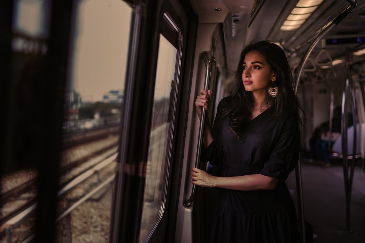 Women Standing In Train Holding Metal Rail While Looking Outside 5k