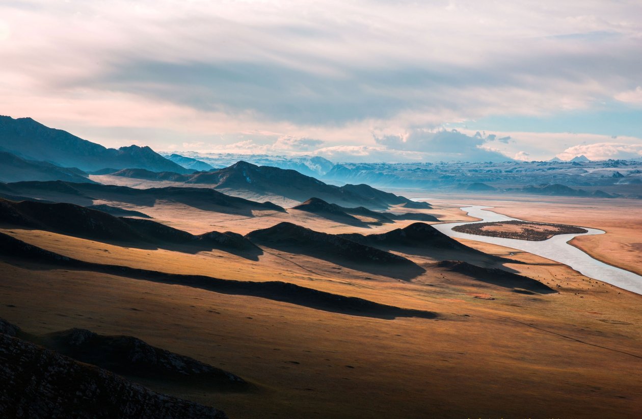Brown Mountains Near Body Of Small Lake