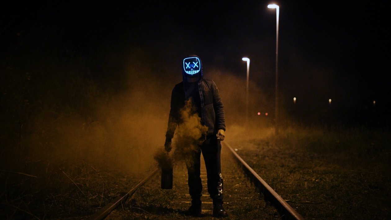 Mask Guy Walking On Railroad
