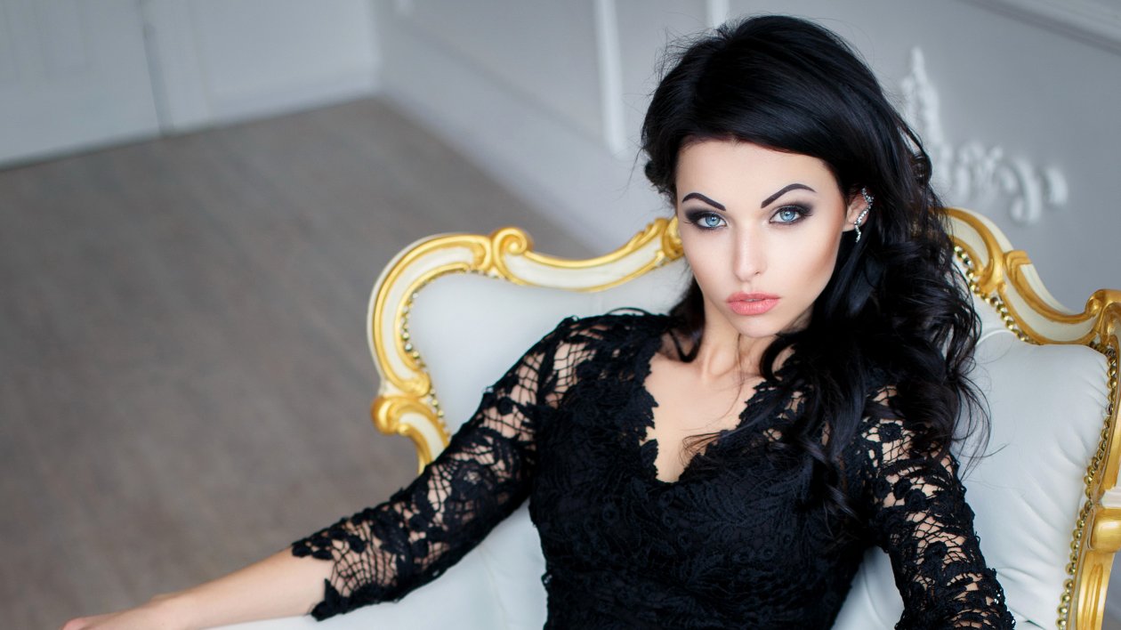 Brunette Girl In Black Dress Sitting