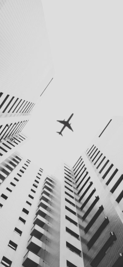 Fond d'écran iPhone Airplane Flying Above Skyscrapers