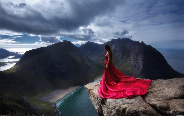 Girl In Red Dress Standing On The Edge Of Mountain Cliff