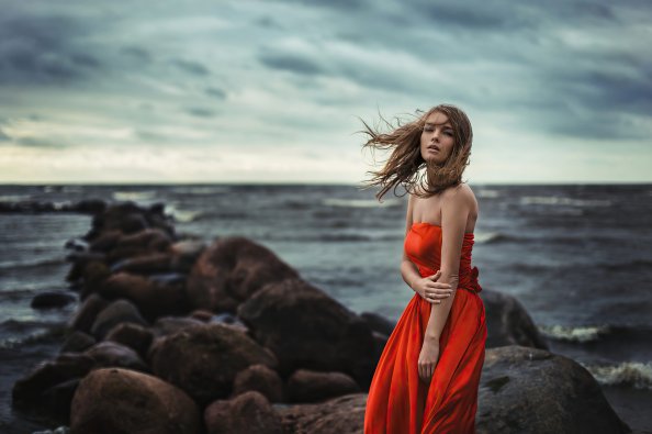 Girl In Orange Dress Wind Blowing At Beach Rocks 4k