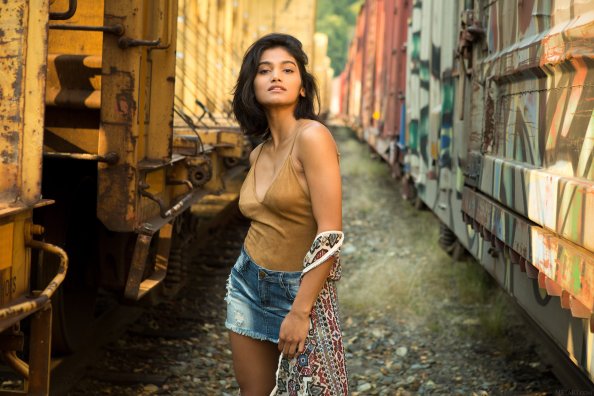Girl Standing Between Two Trains