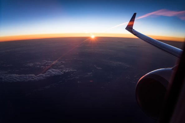 Aerial View Of White Clouds During Sunset Outside Airplane