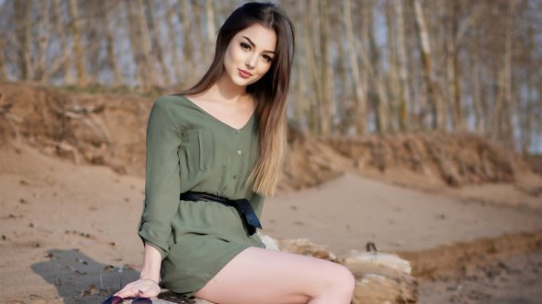 Girl Sitting On Wooden Trunk