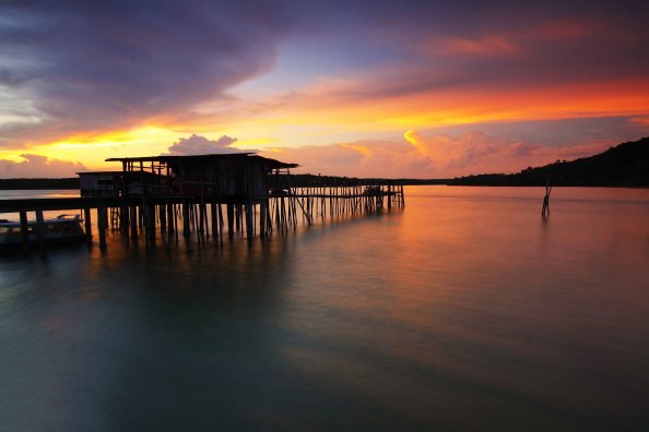 Silhouette Wooden Houses Above Sea Sunet