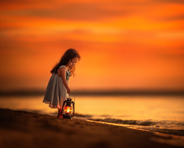 Little Girl On Beach Near Shutdown With Her Lantern