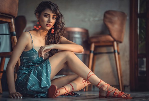 Girl Sitting Inside Looking At Viewer 4k