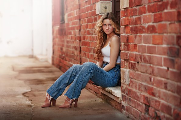 Blonde Girl Sitting Looking At Viewer