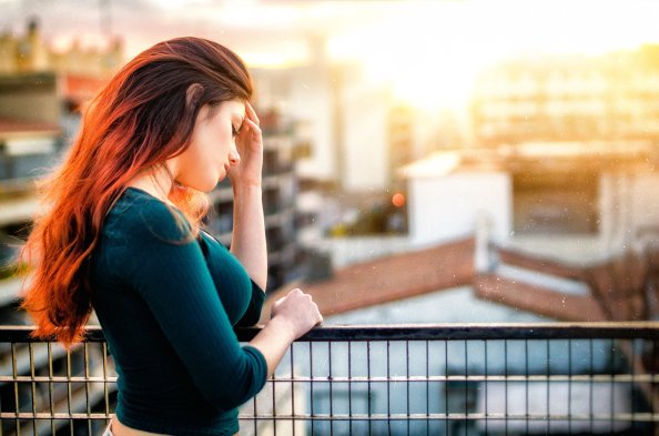 Red Head Model Standing In Balconie