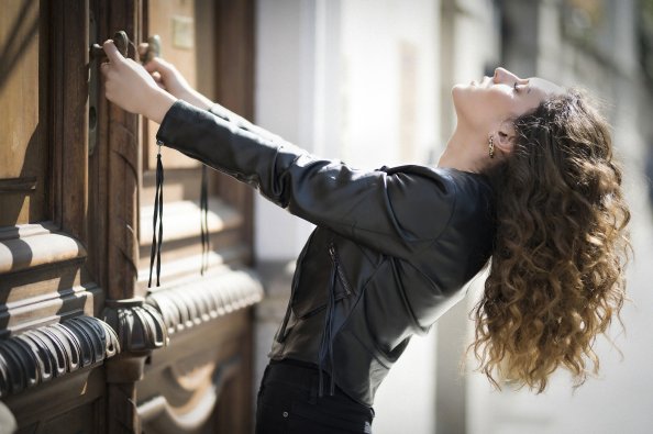 Girl Curly Hair Haning Down Black Jacket 5k