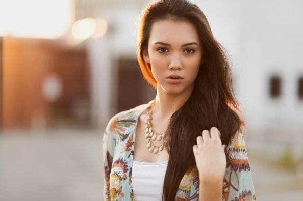 Girl Hands In Hair Looking At Viewer