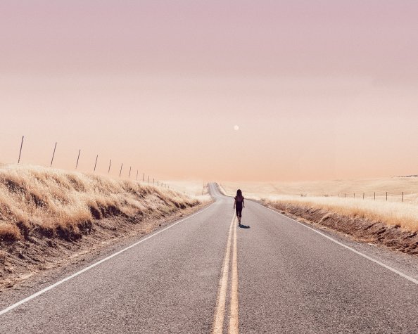 Girl Walking Alone On Desert Road