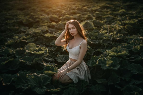 Girl In Vegetable Field Sun Rays From Behind