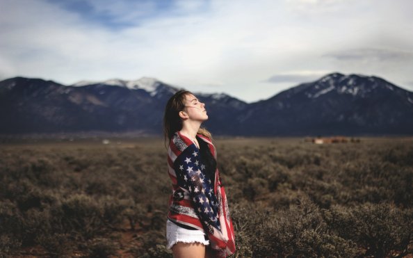 Girl Covering Herself With American Flag