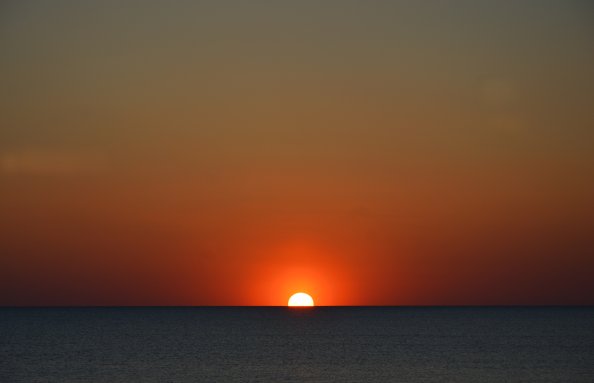 Sun Setting In Body Of Water