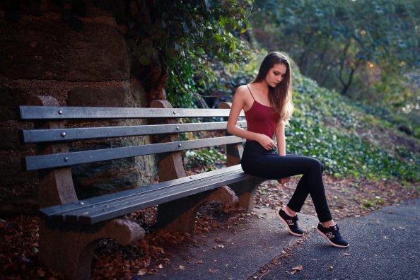 Girl Sitting On Bench Outdoors