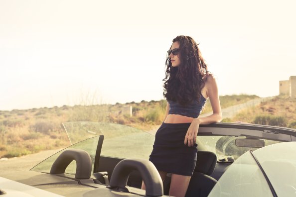 Woman Standing At Convertible Car