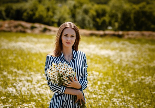 Cute Girl With Flowers In Hand