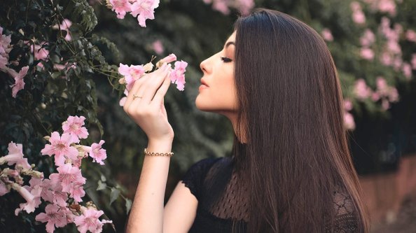 Attractive Beautiful Girl Smelling Flowers