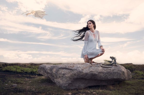 Girl Sitting On Hard Rock With Fantasy Dragons