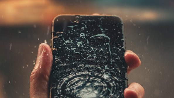 Raindrops On Phone Display In Hand Outdoors 4k